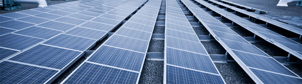 Sets of solar panels on a commercial building's roof top.